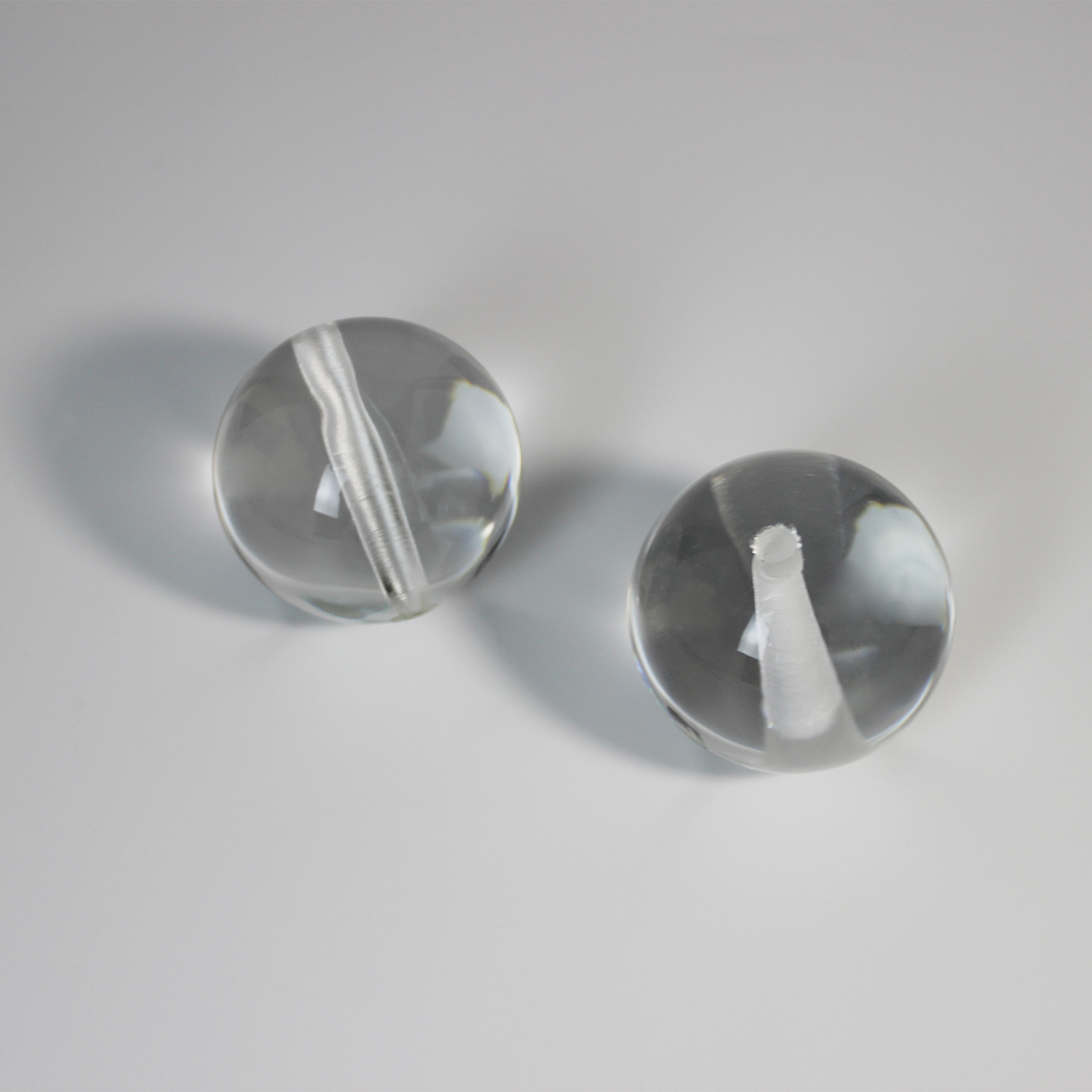 Ball lens with hole for precision optical assembly