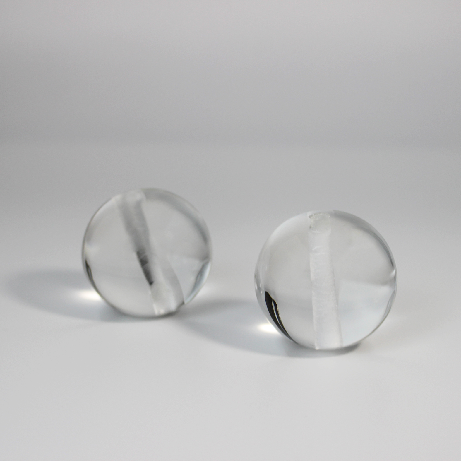 Ball lens with hole for precision optical assembly