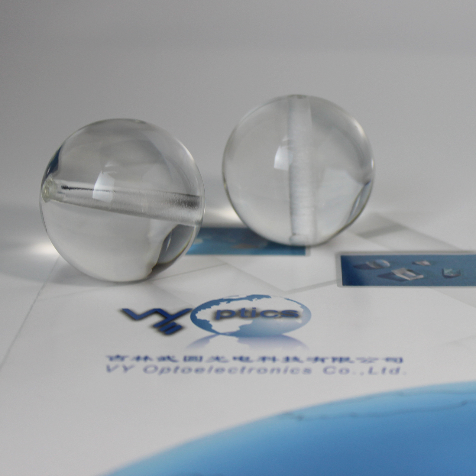 Ball lens with hole for precision optical assembly