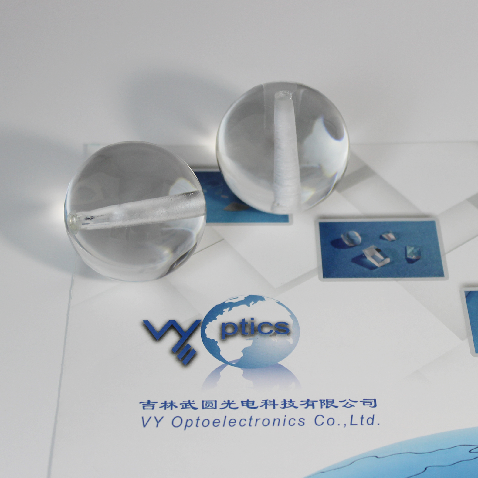 Ball lens with hole for precision optical assembly
