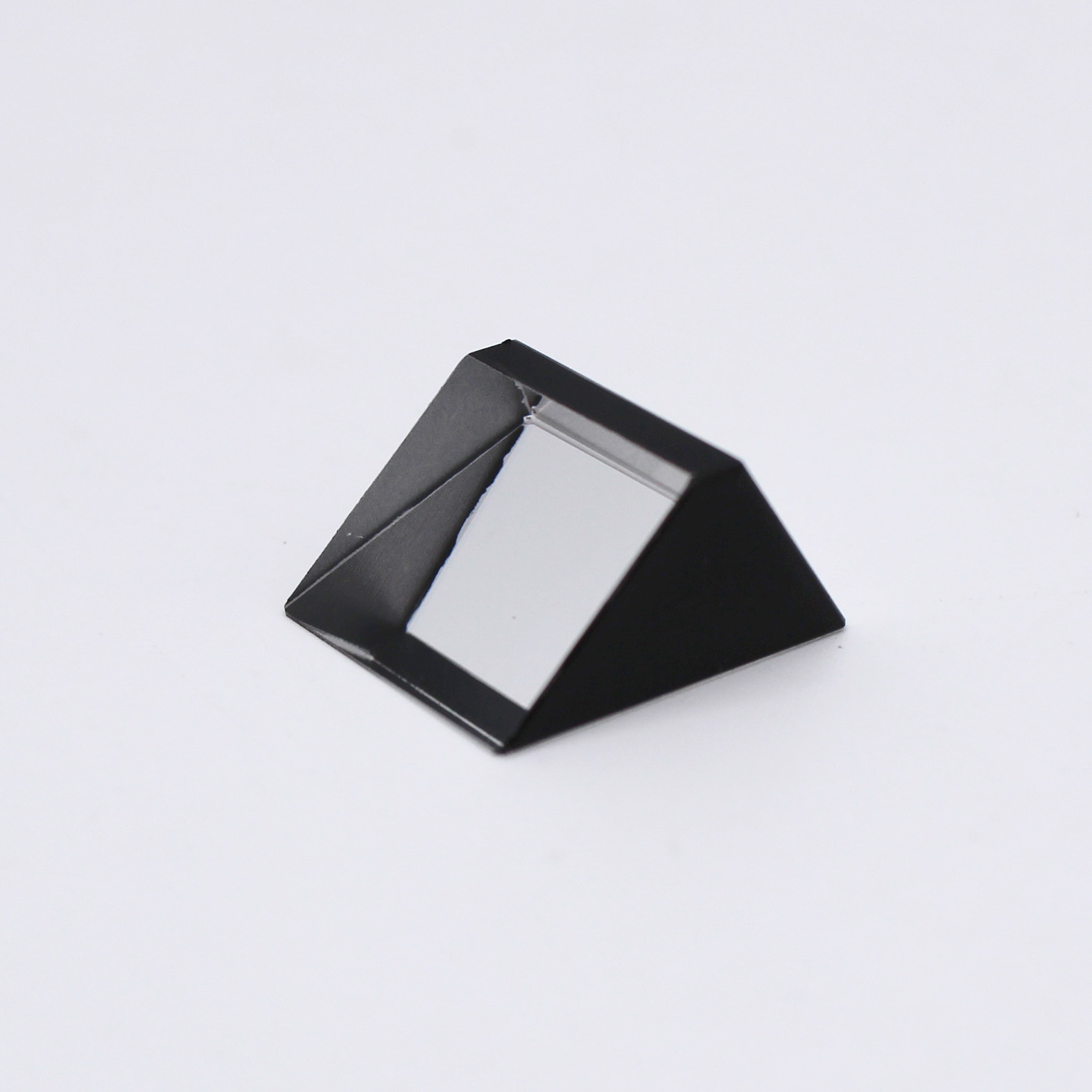 Sapphire optical prism for light reflection and optical system integration