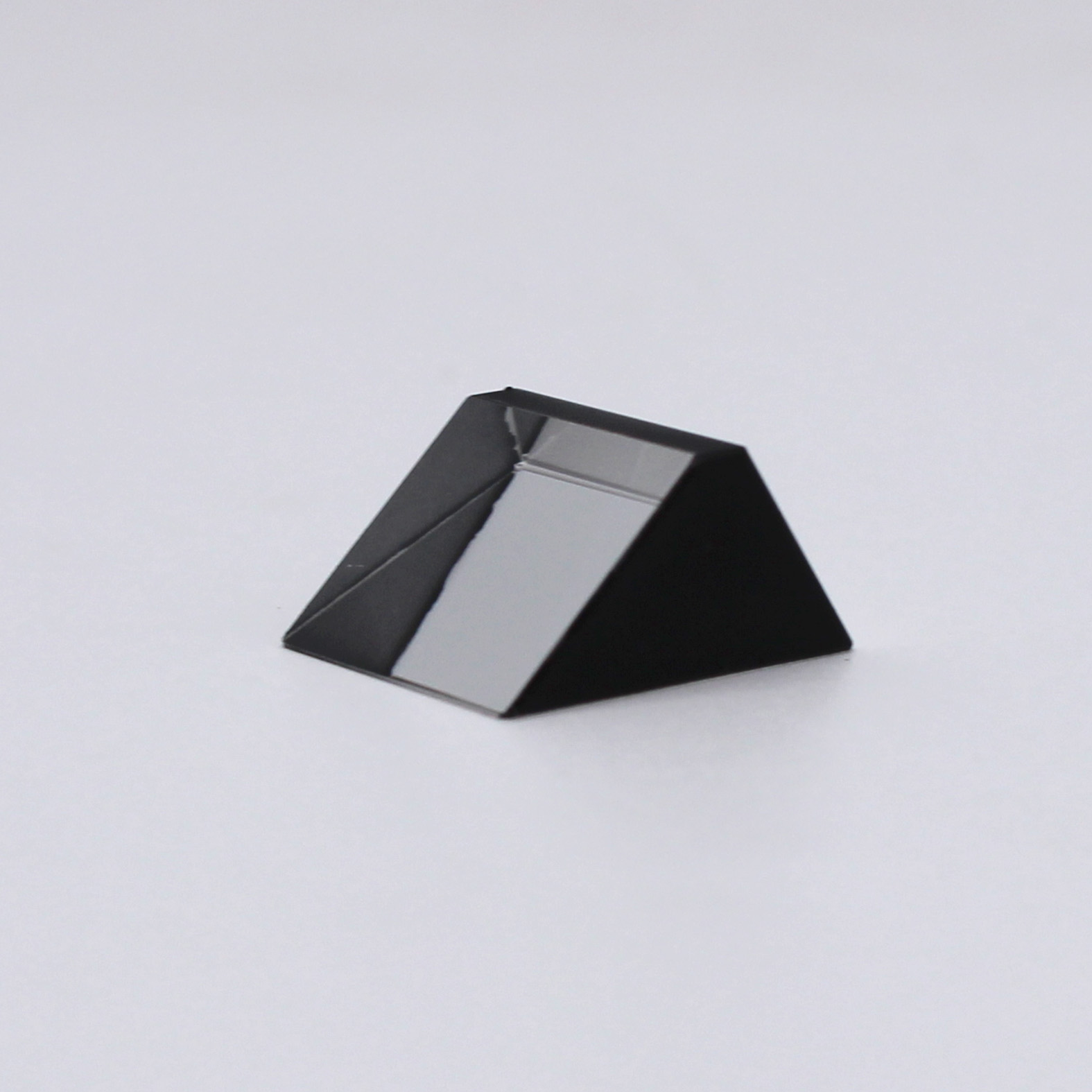 Sapphire optical prism for light reflection and optical system integration